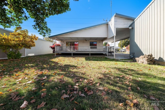 exterior space featuring a yard and ceiling fan