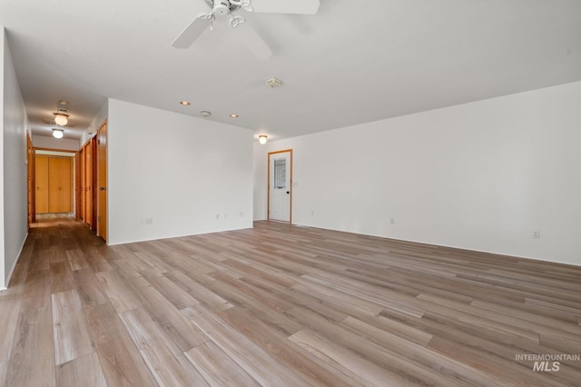 empty room with light hardwood / wood-style floors and ceiling fan