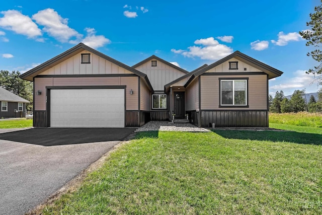 ranch-style home featuring a garage, a front lawn, and driveway