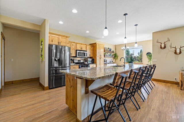 kitchen featuring a sink, recessed lighting, baseboards, and appliances with stainless steel finishes