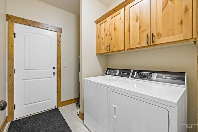 laundry room with separate washer and dryer, cabinet space, baseboards, and light tile patterned flooring