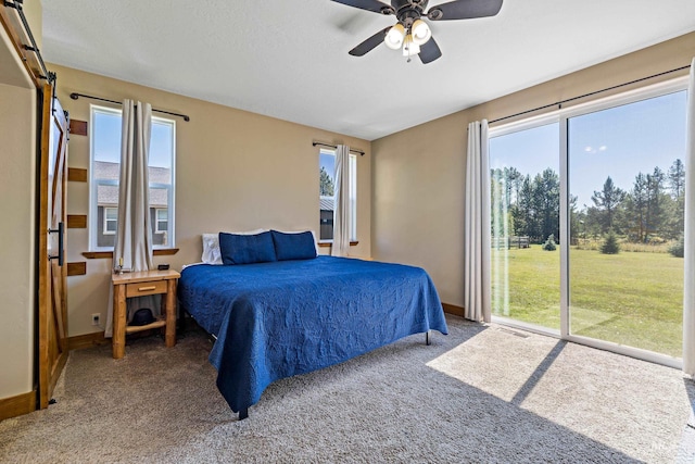 bedroom featuring baseboards, carpet flooring, and access to outside