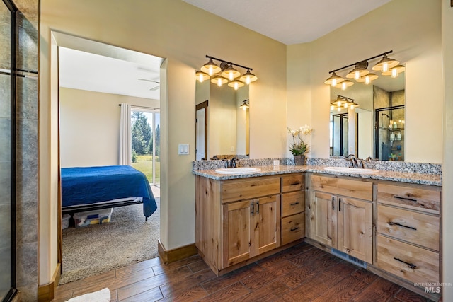 bathroom featuring a sink, double vanity, ensuite bath, and wood finished floors
