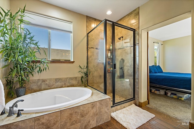 ensuite bathroom featuring a bath, ensuite bath, plenty of natural light, and a stall shower