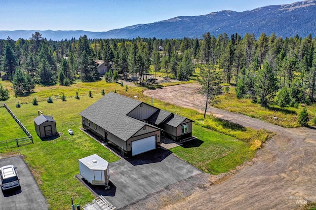 birds eye view of property with a wooded view and a mountain view