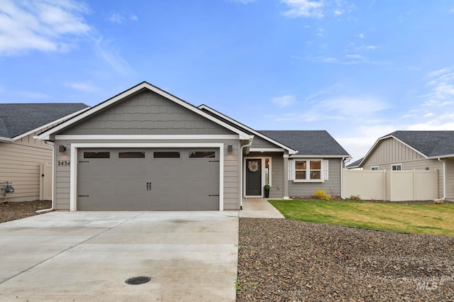 view of front of property featuring a garage and a front lawn