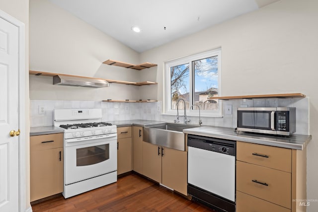 kitchen with white appliances, tasteful backsplash, wall chimney range hood, open shelves, and a sink