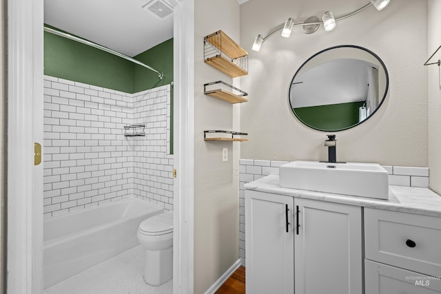 bathroom featuring toilet, shower / tub combination, vanity, and visible vents