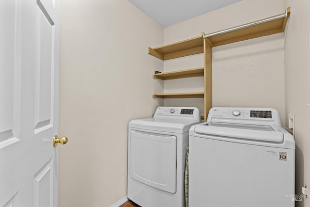 laundry room with laundry area and washing machine and clothes dryer