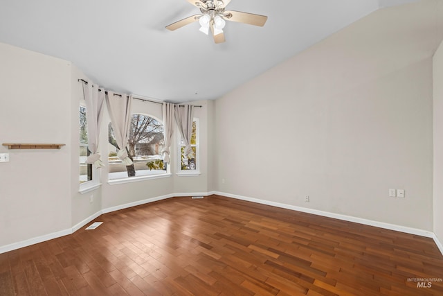 spare room with a ceiling fan, wood finished floors, visible vents, and baseboards