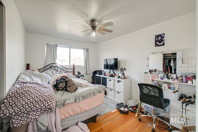 bedroom with ceiling fan and wood finished floors