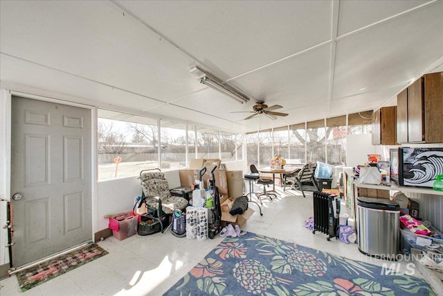 sunroom / solarium featuring ceiling fan