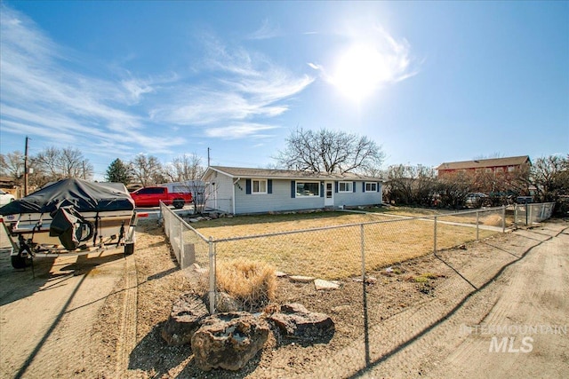 ranch-style house featuring driveway, fence private yard, and a front lawn