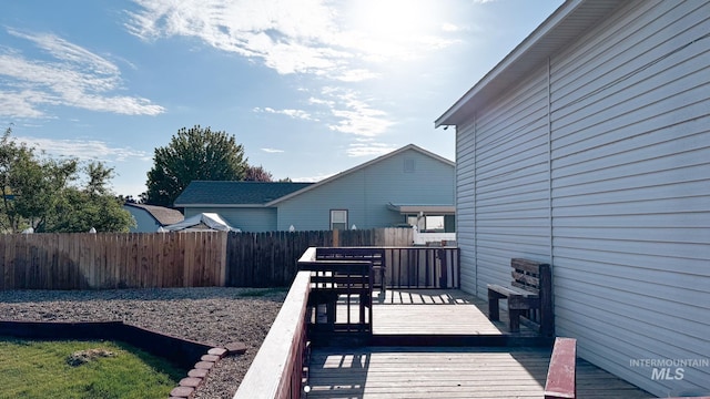 wooden terrace featuring fence