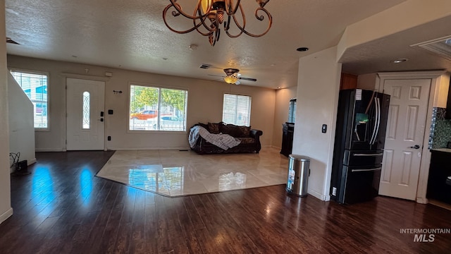 entrance foyer featuring a wealth of natural light, wood finished floors, and baseboards