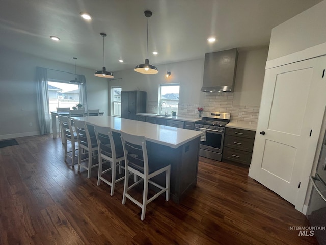 1111 Thunder Mountain St, Kimberly, ID 83341 - kitchen with stainless steel gas range, wall chimney range hood, dark wood-type flooring, a kitchen island, and decorative backsplash