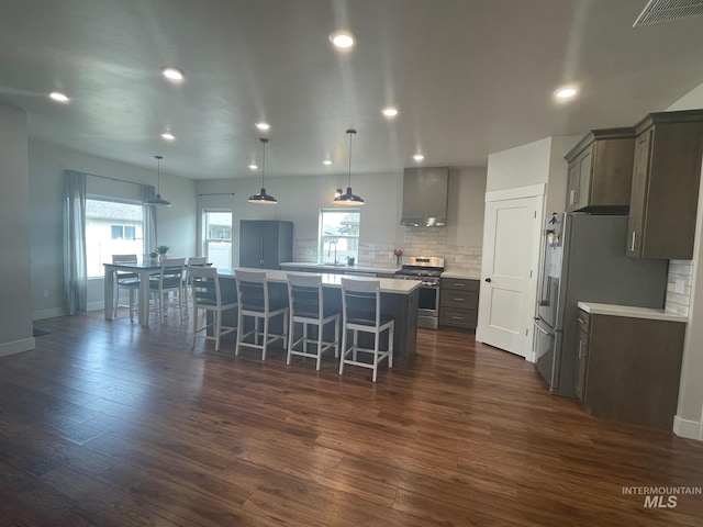 1111 Thunder Mountain St, Kimberly, ID 83341 - kitchen with stainless steel appliances, a large island, wall chimney range hood, decorative backsplash, and dark wood-style flooring