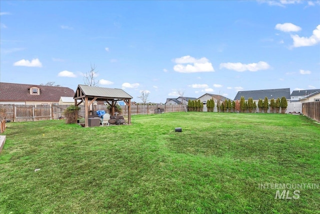 view of yard with a gazebo and a fenced backyard