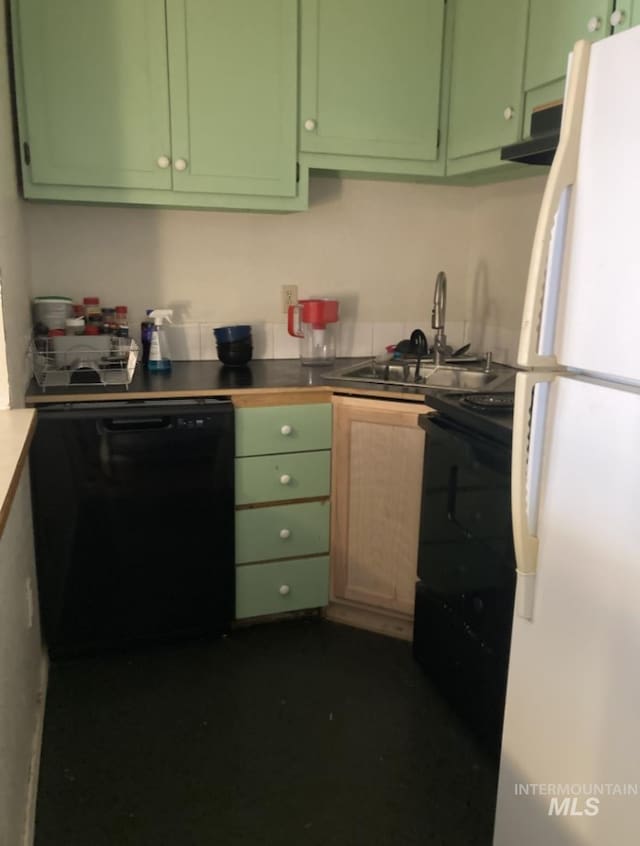 kitchen with a sink, black appliances, and green cabinetry