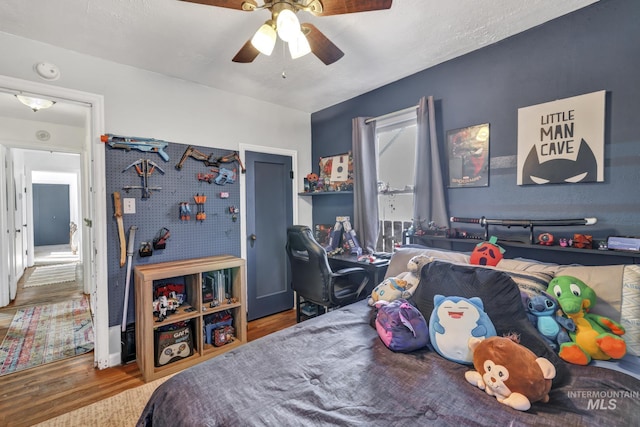 bedroom featuring a ceiling fan and wood finished floors