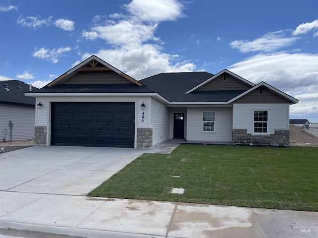 484 Hope Ave, Twin Falls, ID 83301 - craftsman-style home with stone siding, a front lawn, and a garage