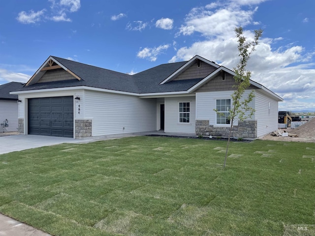 484 Hope Ave, Twin Falls, ID 83301 - view of front of home with stone siding, a garage, a front yard, and concrete driveway