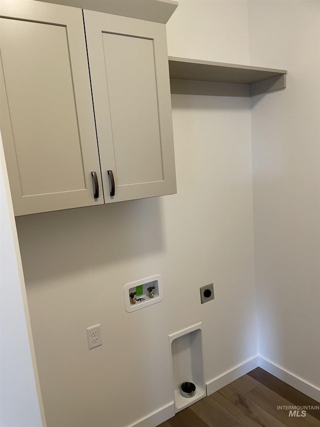 484 Hope Ave, Twin Falls, ID 83301 - washroom featuring hookup for a washing machine, electric dryer hookup, dark wood finished floors, baseboards, and cabinet space