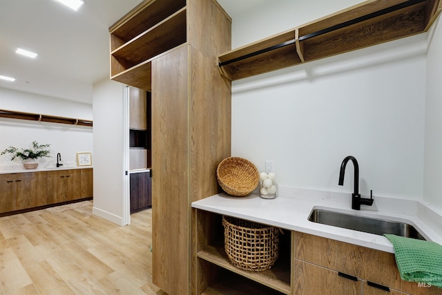 interior space with light hardwood / wood-style flooring and sink