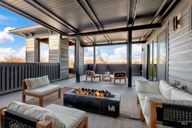 view of patio / terrace featuring an outdoor living space with a fire pit