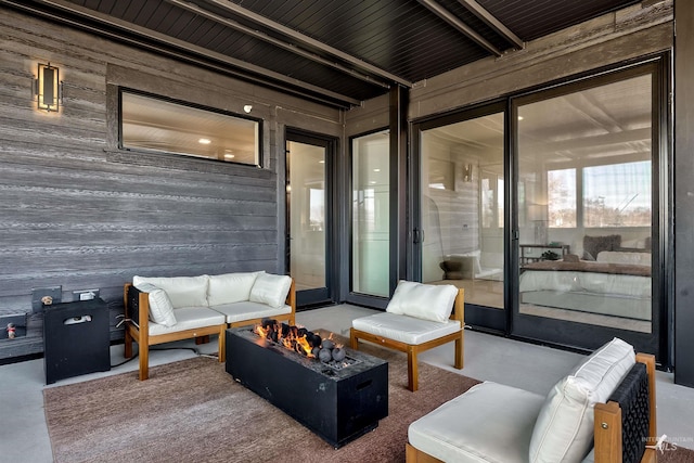 view of patio featuring an outdoor living space with a fire pit