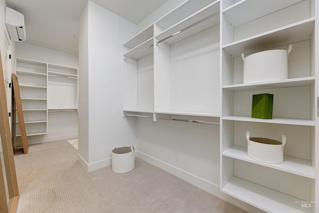 spacious closet featuring light colored carpet and a wall mounted AC