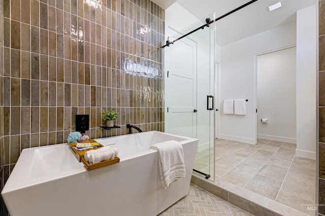 bathroom featuring tile walls, shower with separate bathtub, and tile patterned flooring