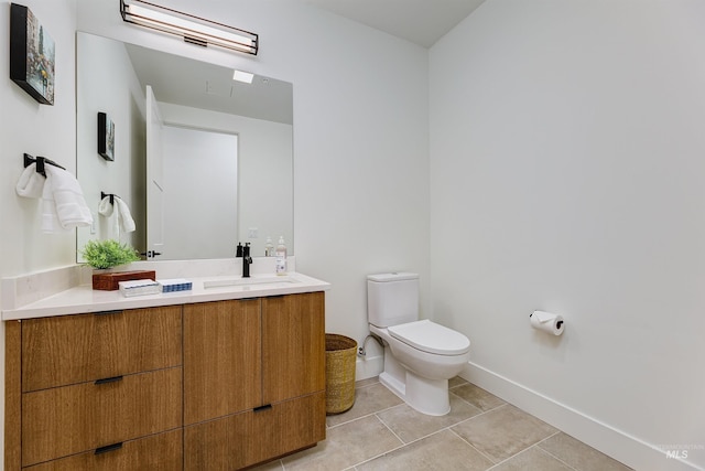 bathroom featuring tile patterned floors, toilet, and vanity