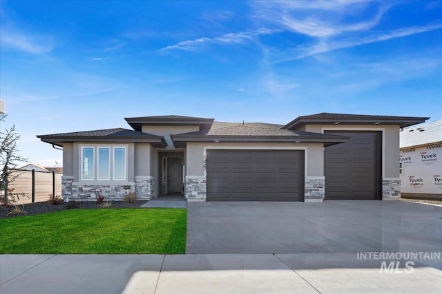 8447 W Happy Day Dr, Meridian, ID 83646 - prairie-style house featuring stone siding, an attached garage, stucco siding, concrete driveway, and a front lawn
