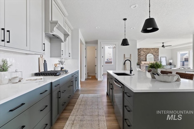 8447 W Happy Day Dr, Meridian, ID 83646 - kitchen featuring a sink, stainless steel appliances, a textured ceiling, open floor plan, and light countertops