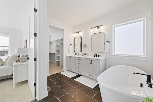 8447 W Happy Day Dr, Meridian, ID 83646 - bathroom featuring healthy amount of natural light, double vanity, a soaking tub, and ensuite bathroom