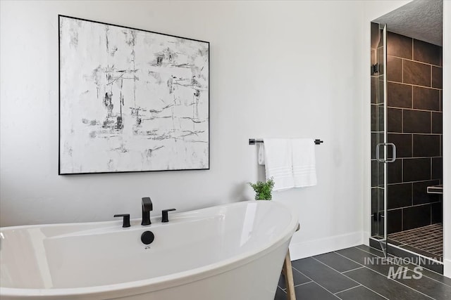 8447 W Happy Day Dr, Meridian, ID 83646 - full bath featuring a freestanding bath, a shower stall, tile patterned floors, and baseboards