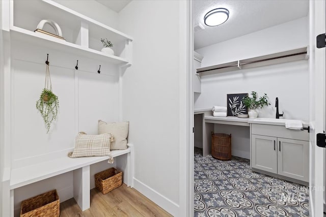 8447 W Happy Day Dr, Meridian, ID 83646 - mudroom featuring baseboards, a sink, and light wood-type flooring