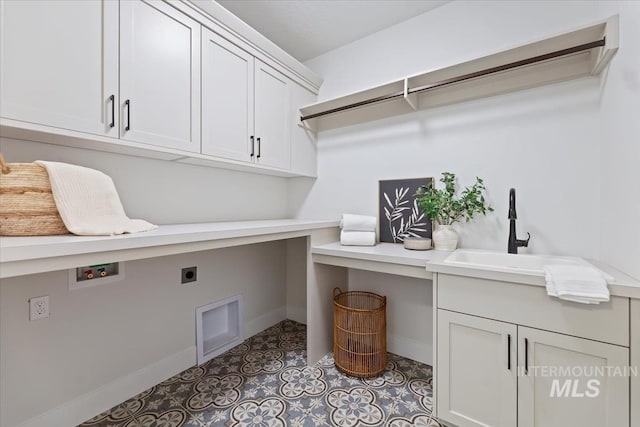 8447 W Happy Day Dr, Meridian, ID 83646 - laundry area with cabinet space, baseboards, hookup for a washing machine, hookup for an electric dryer, and an office area