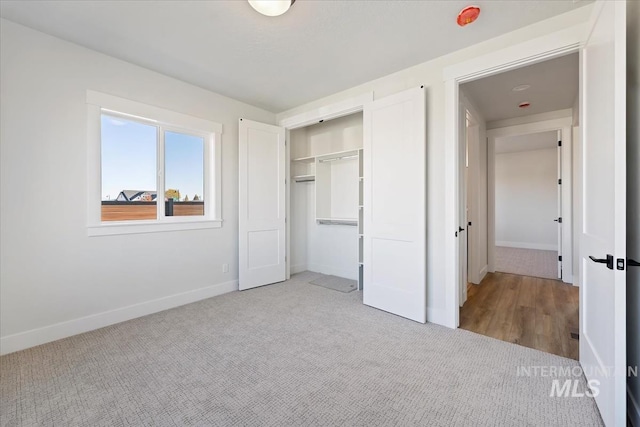 8447 W Happy Day Dr, Meridian, ID 83646 - unfurnished bedroom featuring carpet floors, baseboards, and a closet