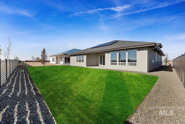 8447 W Happy Day Dr, Meridian, ID 83646 - rear view of property featuring roof mounted solar panels, stucco siding, and a patio