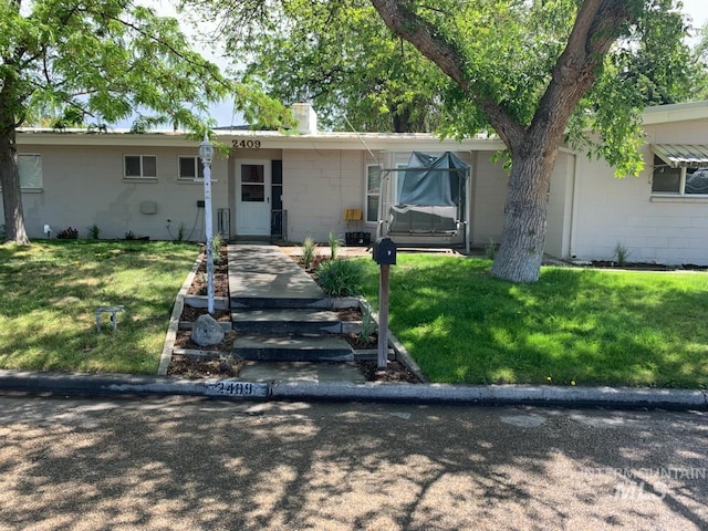 2409 S Ohio, Caldwell, ID 83605 - ranch-style home featuring concrete block siding, a front lawn, and a chimney