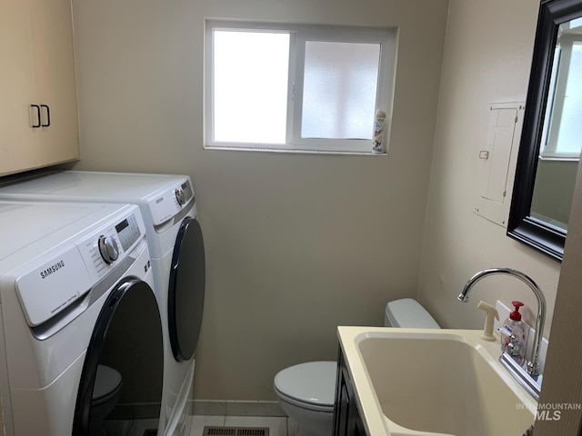 2409 S Ohio, Caldwell, ID 83605 - washroom featuring independent washer and dryer, plenty of natural light, and tile patterned floors