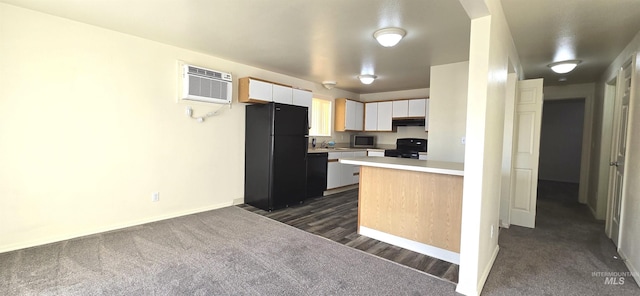 kitchen with white cabinets, a wall mounted air conditioner, under cabinet range hood, light countertops, and black appliances