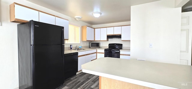 kitchen with white cabinets, under cabinet range hood, light countertops, black appliances, and a sink