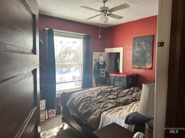 carpeted bedroom with multiple windows, a textured ceiling, and ceiling fan