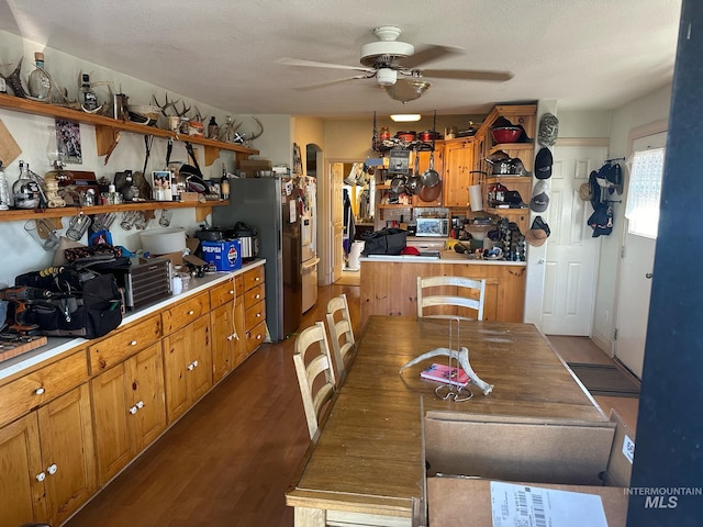 kitchen featuring ceiling fan, stainless steel refrigerator, hardwood / wood-style floors, and a textured ceiling