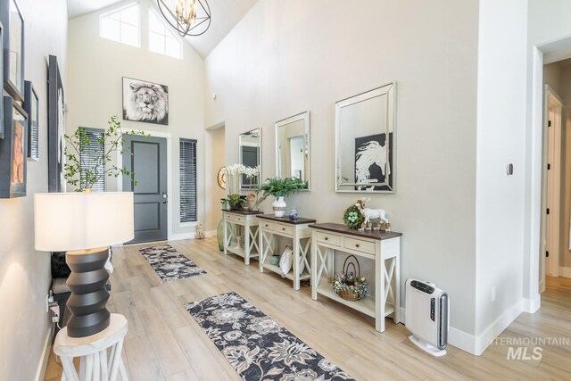6087 S Pioneer Trail Way, Meridian, ID 83642 - foyer entrance featuring a chandelier, light wood-type flooring, baseboards, and high vaulted ceiling