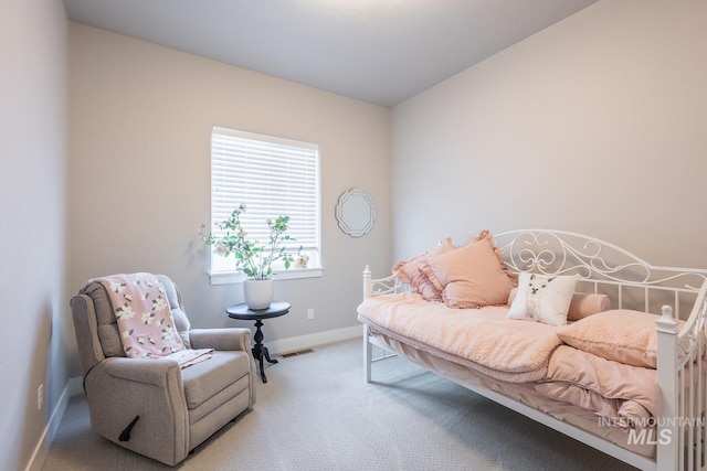 carpeted bedroom featuring baseboards and visible vents