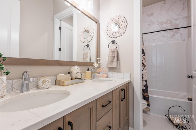 full bathroom featuring double vanity, shower / tub combo, toilet, and a sink